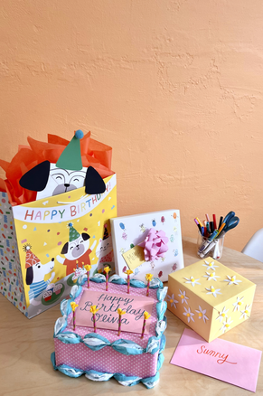 Gifts in gift bags, gift wrap, bows and more with a birthday theme