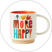 a mug that reads More Happy in colorful lettering