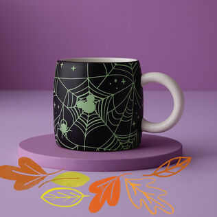A mug featuring the mickey mouse logo in spiderwebs.