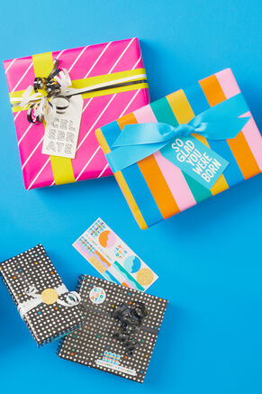 Multiple gift-wrapped gifts with ribbons and gift tags.