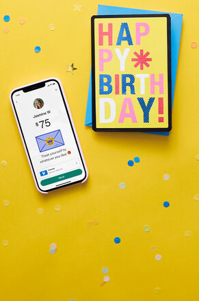 Happy birthday card with digital gift card showing on a phone.